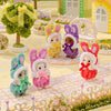 Calico Critters bunnies in different color matching outfits.